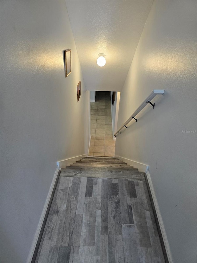 stairway with hardwood / wood-style floors