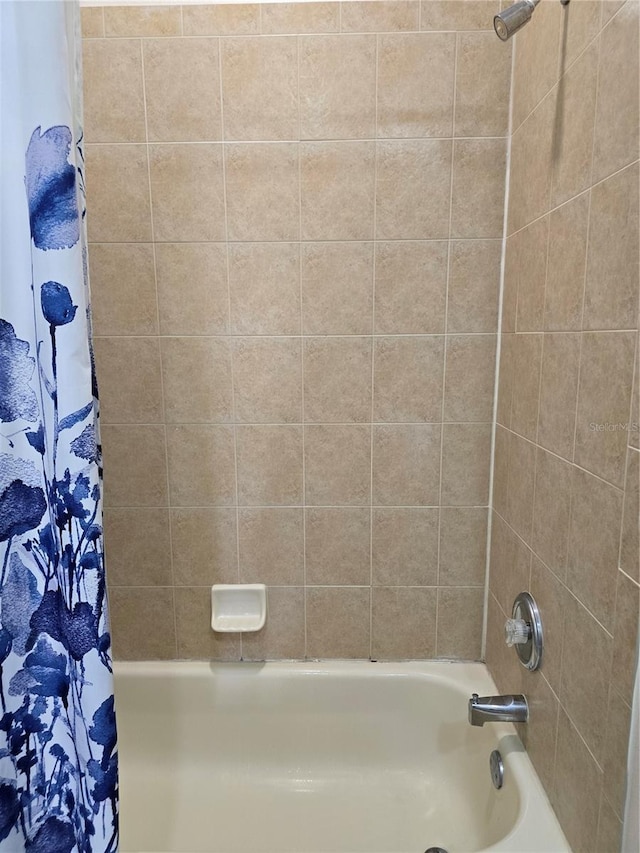 bathroom with shower / bath combo with shower curtain