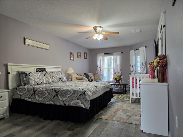 bedroom with a textured ceiling and ceiling fan