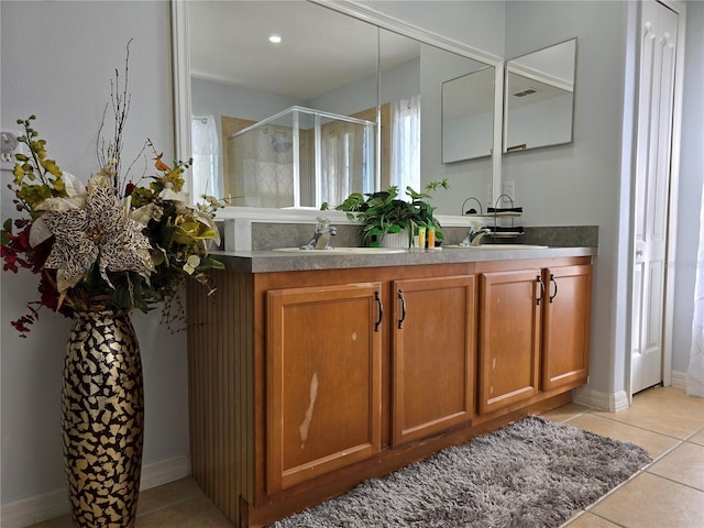 bathroom featuring vanity, tile patterned floors, and walk in shower