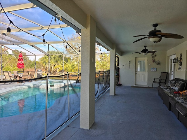 view of swimming pool featuring a lanai, ceiling fan, and a patio