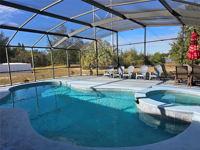 view of pool with a lanai, an in ground hot tub, and a patio