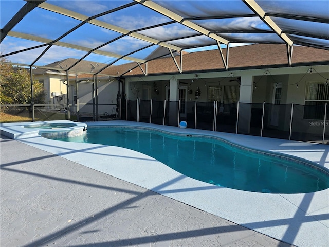 view of pool featuring an in ground hot tub, a lanai, ceiling fan, and a patio area