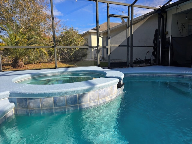 view of pool with an in ground hot tub and a lanai