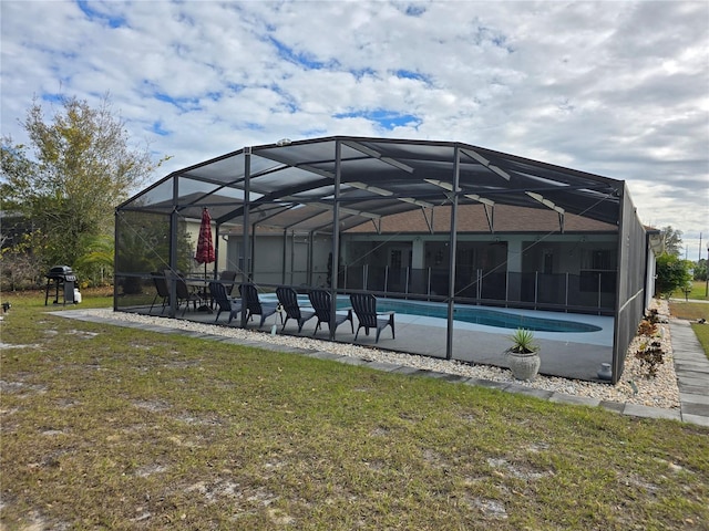 exterior space featuring a lanai, a lawn, and a grill