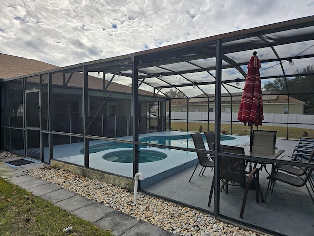 view of pool with an in ground hot tub, a lanai, and a patio area