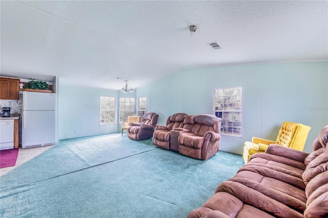 living room featuring light carpet, a textured ceiling, lofted ceiling, and a notable chandelier