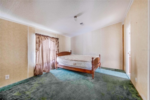 unfurnished bedroom featuring a textured ceiling, ornamental molding, and dark carpet