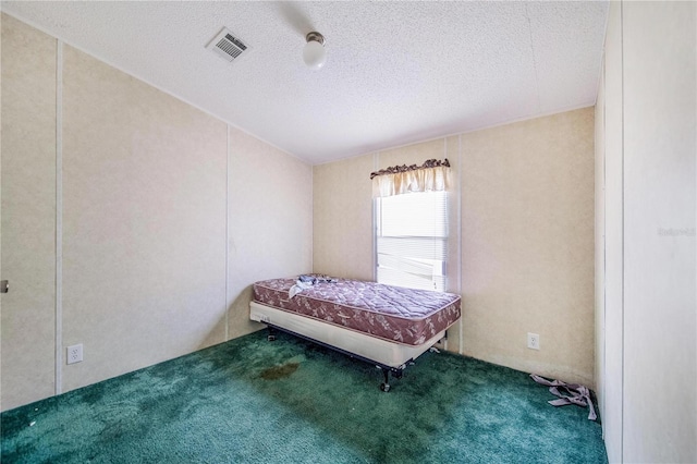 unfurnished bedroom featuring a textured ceiling and carpet flooring