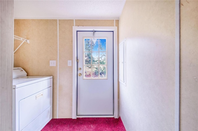 laundry area featuring washer / clothes dryer and a textured ceiling