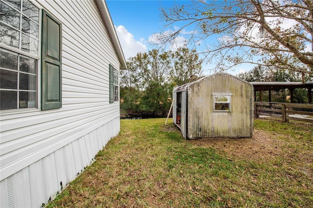 view of home's exterior featuring a lawn and a shed