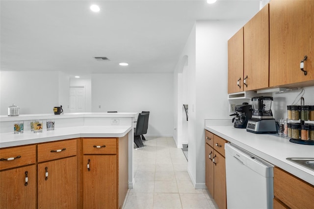 kitchen with light tile patterned floors and white dishwasher