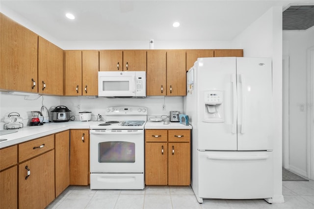 kitchen with light tile patterned floors and white appliances