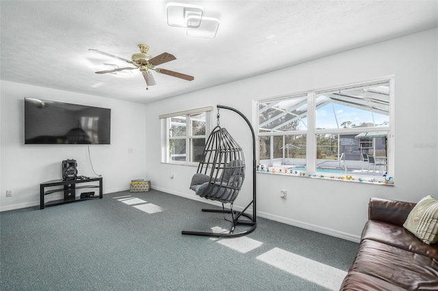 workout room featuring ceiling fan, a textured ceiling, and carpet flooring