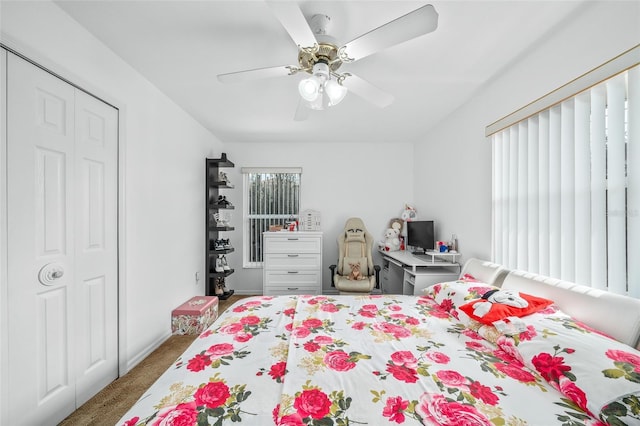 carpeted bedroom with ceiling fan and a closet