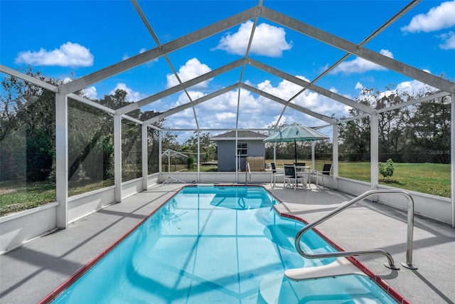 view of pool with glass enclosure, a gazebo, and a patio