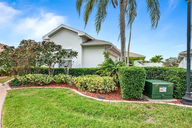 view of home's exterior with a lawn