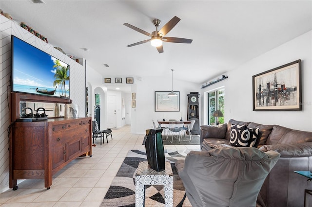 tiled living room featuring ceiling fan and lofted ceiling