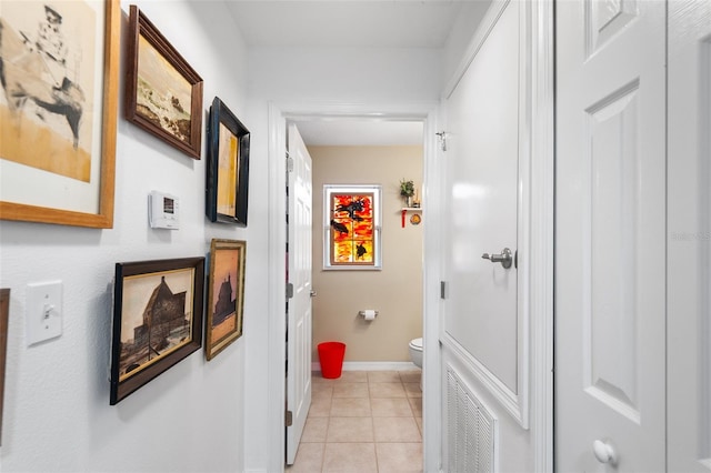 corridor featuring light tile patterned floors