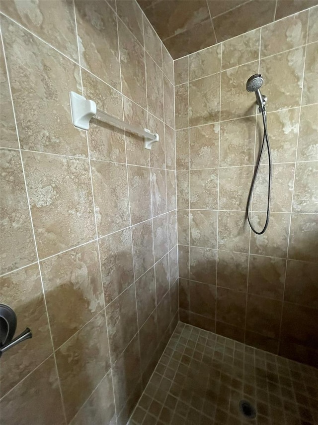 bathroom with a tile shower