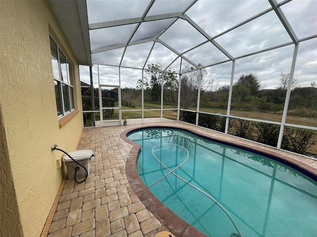 view of pool with a lanai and a patio