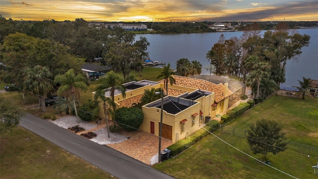 aerial view at dusk with a water view