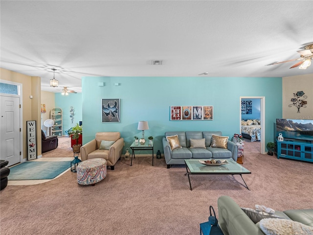 carpeted living room featuring ceiling fan