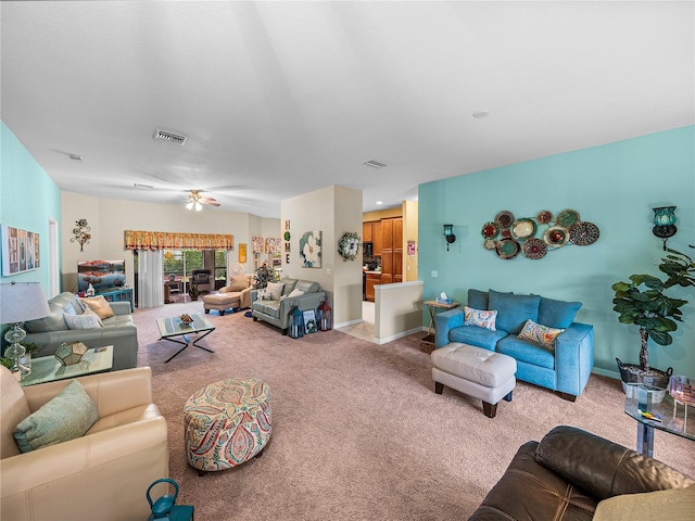 living room with ceiling fan and light carpet