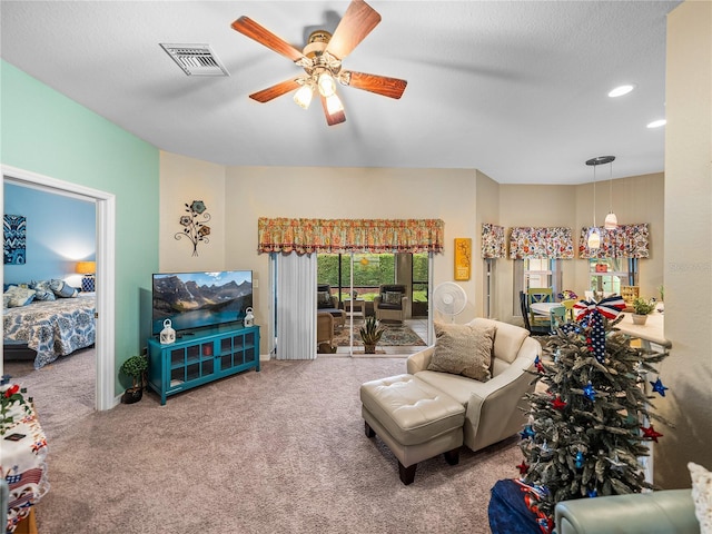 carpeted living room featuring ceiling fan