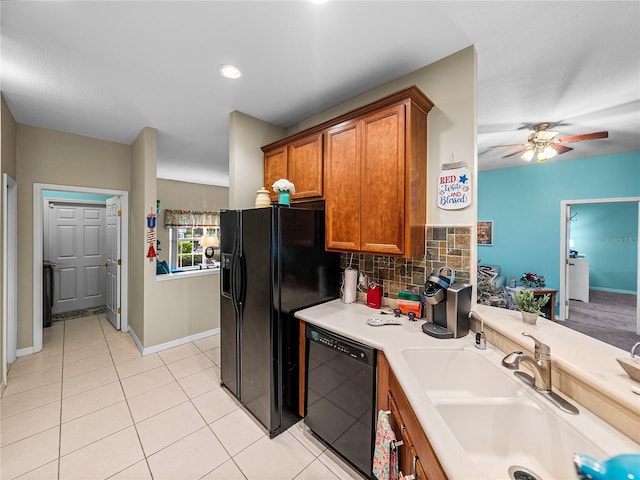 kitchen featuring sink, light tile patterned floors, ceiling fan, black appliances, and decorative backsplash