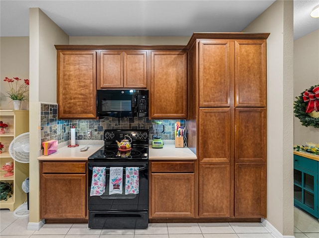 kitchen with light tile patterned flooring, decorative backsplash, and black appliances