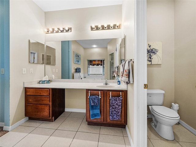 bathroom featuring tile patterned flooring, vanity, and toilet