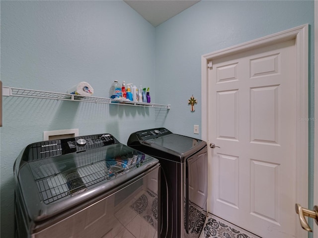 laundry room with tile patterned flooring and washer and dryer