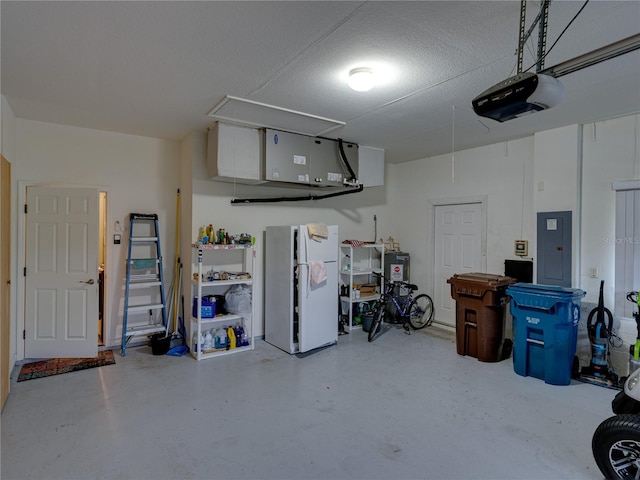 garage with a garage door opener and electric panel