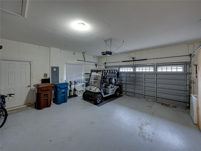 garage featuring a garage door opener and electric panel