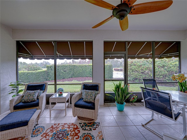 sunroom / solarium featuring ceiling fan