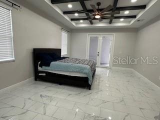 bedroom with coffered ceiling, french doors, and beamed ceiling