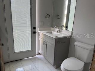 bathroom featuring vanity and toilet