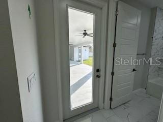 doorway featuring ceiling fan