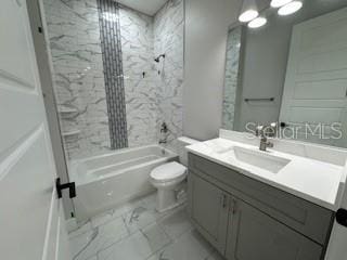 full bathroom featuring vanity, toilet, and tiled shower / bath