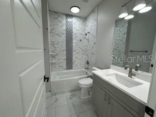 full bathroom with tiled shower / bath, vanity, and toilet