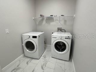 laundry room with washing machine and clothes dryer