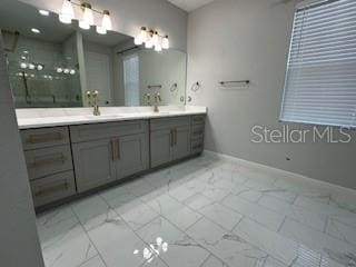 bathroom with walk in shower and vanity