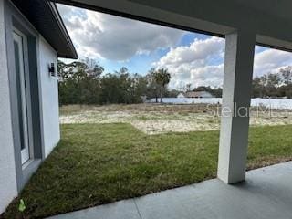 view of yard with a water view and a patio