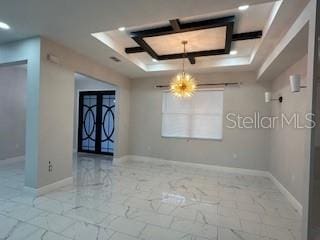 empty room featuring a raised ceiling