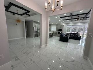 interior space with coffered ceiling and a notable chandelier