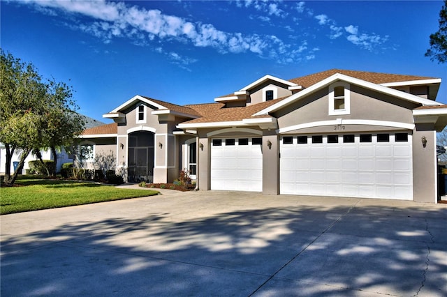 view of front of property with a garage and a front lawn