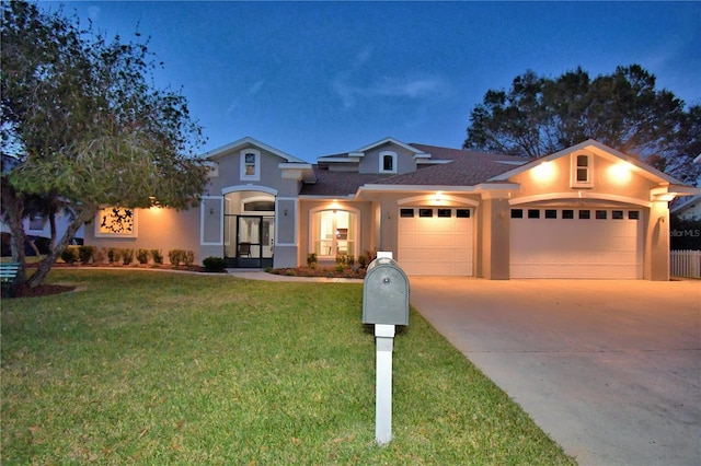 view of front facade featuring a garage and a front lawn