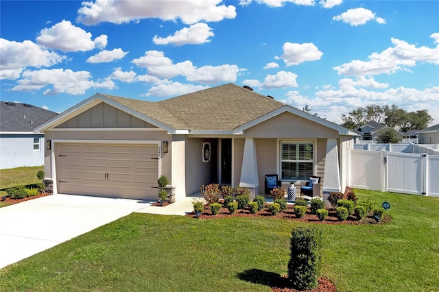 view of front of home with a garage, covered porch, and a front yard