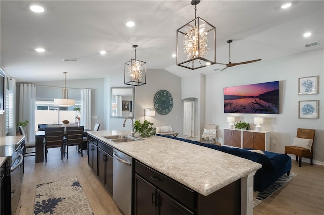 kitchen with lofted ceiling, sink, hanging light fixtures, a kitchen island with sink, and stainless steel dishwasher